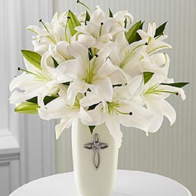 <p>This striking display of pure white lilies will send your heartfelt expressions when words just aren't enough. Arranged in a white ceramic vase and enhanced by a cross, this arrangement is perfect for celebrations, confirmations, sympathy, weddings, or a special anniversary.This is an all-around arrangement.</p>