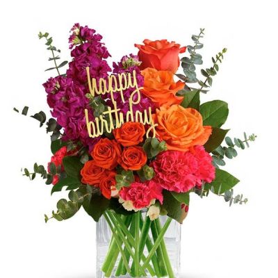 <p>Fill someone's birthday with color! This brightly colored birthday flower bouquet is created with mixed floral stems including orange roses, pink carnations and orange spray roses. All the beautiful flowers are hand arranged by a florist near you in a glass cube vase. Note: Happy Birthday pick may vary depending on local florist's availability.</p>